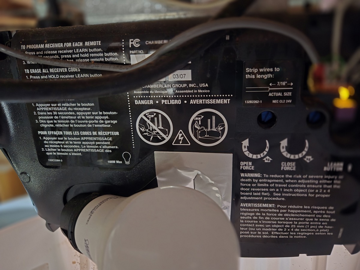 Chamberlain garage door opener showing the LEARN button and programming instructions